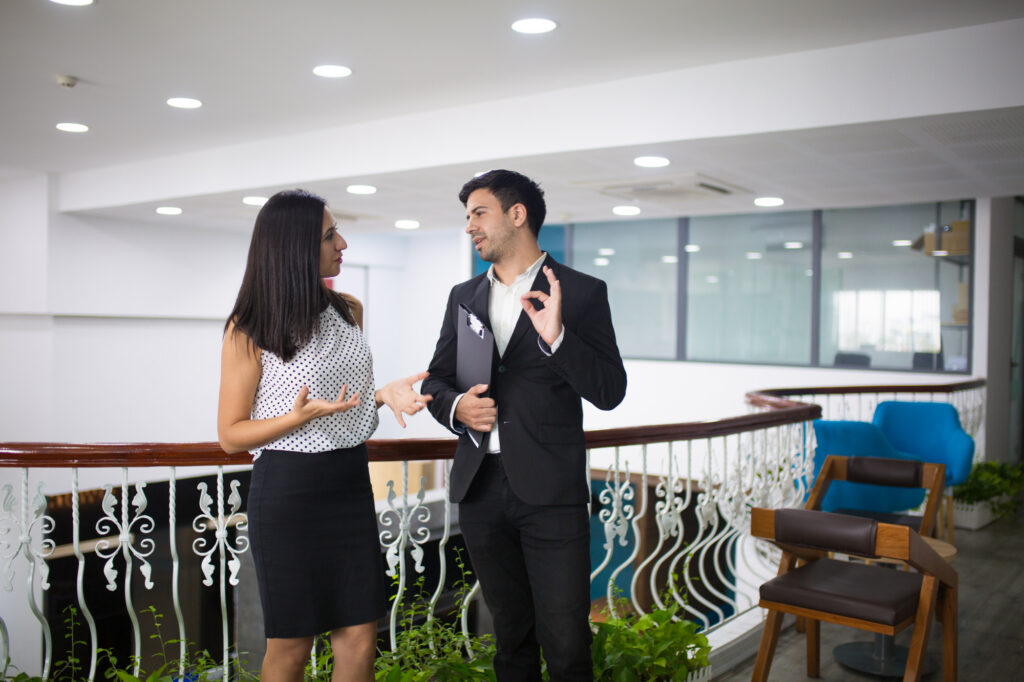 portrait-happy-young-colleagues-partners-talking-hall