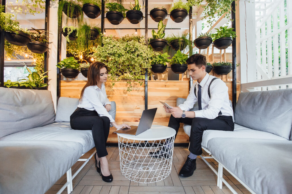 Employees on businesswomen with a laptop in classical clothing.